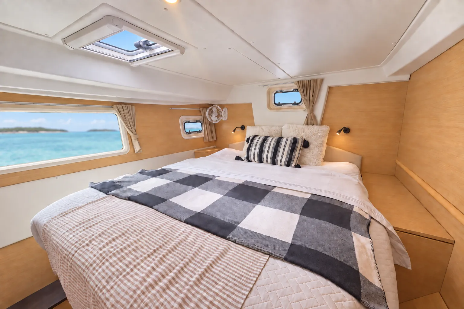 En-suite cabin on the Lagoon 500 with a queen berth and turquoise water outside